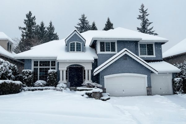 Snow falling in Front yard of modern suburban home